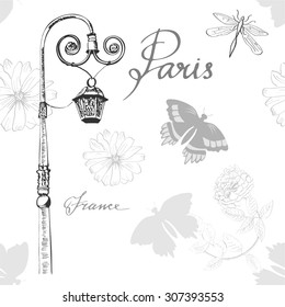 A seamless vector pattern with a lamp post, butterflies and flowers, and words 'Paris' and 'France' written in calligraphy