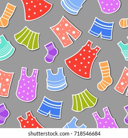 Seamless vector pattern with lots of colorful clothes and spots around. Cute bright wrapping with dresses, trousers, socks and skirts on a gray background. Summer illustration.