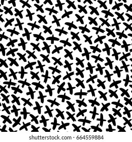 Seamless vector pattern made of hand drawn brush strokes resembling birds. Monochrome design for web or print.