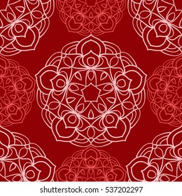 Seamless vector pattern. Mandala bright pattern in red colors on the dark red background.