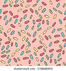 
Seamless vector pattern. multi-colored confiti on a pink background. colored dots topping for ice cream. holiday background for wrapping, holiday decoration, fabric, wallpaper.