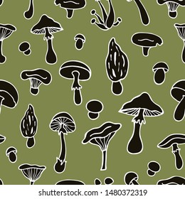 Seamless vector pattern of mushrooms. Black mushrooms with a white outline on a green background.