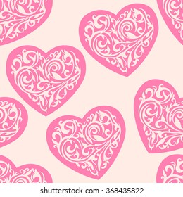 Seamless vector pattern with ornate hearts. Hearts from floral tracery on a light background. Wallpaper with hearts for Valentine's day.