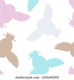 Seamless vector pattern with pink, grey, blue, brown owls. Repetitive background with vector flat multicolored birds. Owls in the repetitive seamless vector pattern.
