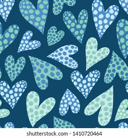 Seamless vector pattern with polka dot hearts in blue tones.