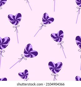 Seamless vector pattern with purple heart shaped lollipops. A cute, delicate dessert for Valentine's Day. Sweet lovely candy design for invitations, banners, greeting cards, posters.