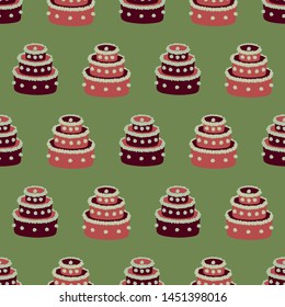 A seamless vector pattern with red christmas cakes on green background. Surface print design.
