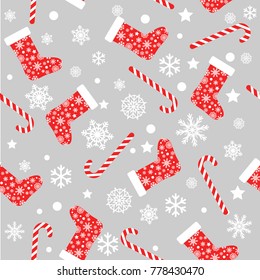 Seamless vector pattern with red and white christmas stocking socks, candy canes and snowflakes
