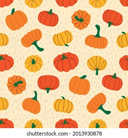 Seamless vector pattern of ripe pumpkins and stripes on a beige background