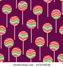 A seamless vector pattern with round rainbow colored lollipops. Surface print design.