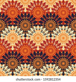 A seamless vector pattern with rows of decorative mandalas in red, navy blue, and white colors. Ornamental surface print design. Great for fabrics, stationery and packaging.