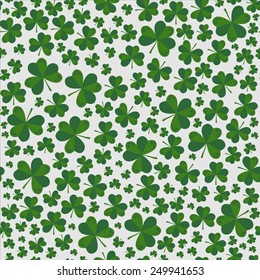 Seamless vector pattern with shamrocks on the day of St. Patrick, green on a white background