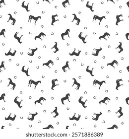 Seamless vector pattern, silhouettes of horses and horseshoes, chaotic arrangement