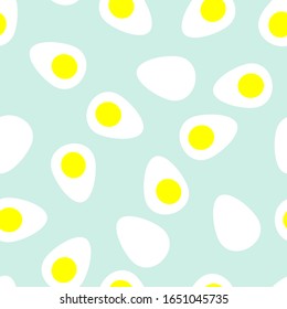 Seamless vector pattern with sliced boiled eggs, halfs of chicken eggs on blue background