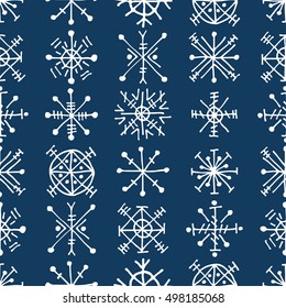 Seamless vector pattern with snowflakes. Blue winter background with decorative hand drawn snow flakes. Graphic illustration. Series of winter seamless vector patterns.