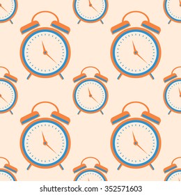 Seamless vector pattern. Symmetrical background with orange closeup alarm clocks on the light background.