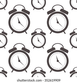 Seamless vector pattern. Symmetrical background with closeup black alarm clocks on the white background.