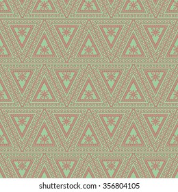 Seamless vector pattern. Symmetrical geometric background with red triangles on the green backdrop. Decorative ornament.