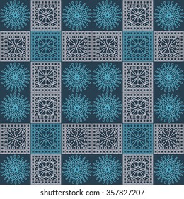 Seamless vector pattern. Symmetrical geometric background with blue and light pink squares and circles on dark blue backdrop. Decorative ornament.