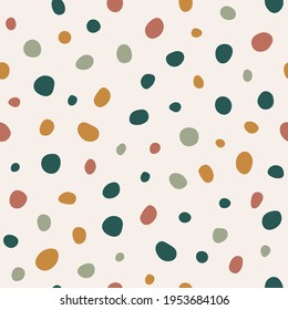 Seamless vector pattern in Terrazzo style. Stylized granite texture. Imitation of chaotically scattered colorful stones. Large multi-colored polka dots. Abstract pattern for printing.