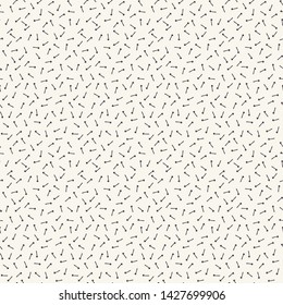 Seamless vector pattern. Tiny hand drawn arrow confetti shapes. Repeating geo background. Monochrome surface design textile swatch, modern black white wallpaper, fun geo sprinkles all over print. 