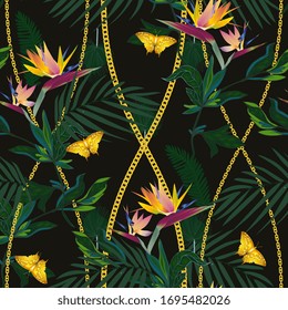 Seamless vector pattern with tropical jungle plants. Strelitzia flowers, palm leaves, gold chains and gold butterflies on a black colored background. Modern trendy design for fabric, scarves.
