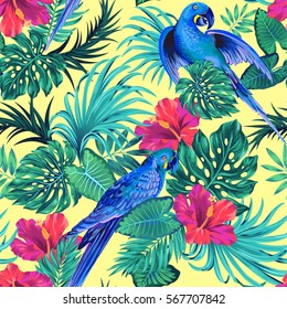 seamless vector pattern with tropical parrots. blue birds, hibiscus flower, monstera and palm leaves, beautiful composition for swimwear, active wear.