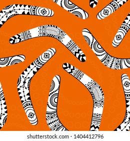 Seamless vector pattern with various black and white boomerangs on orange background
