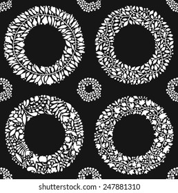 Seamless vector pattern with white wreaths on a black background