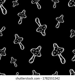 Seamless vector pattern with wild mushrooms. Inedible mushrooms. Decorative toadstool. Stylized illustration. Halloween, an autumn holiday. White lines on a black background.