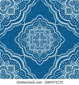seamless vector repeat pattern, intricate mandala tile design in white on a blue background