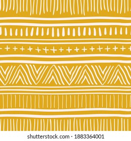 seamless vector repeat pattern, tribal inspired design in white on a mustard yellow background 