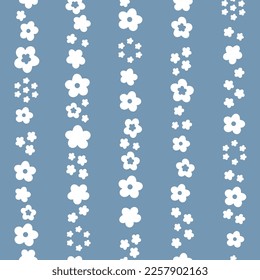 Seamless vector repeat pattern with white Spring flowers in vertical stripes, over a blue background.