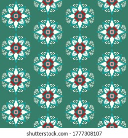Seamless vector repeating tile of snowflake shaped flowers in white and red in a green background. Ornate floral with intricate detail good for Christmas and festive prints and apparel print.