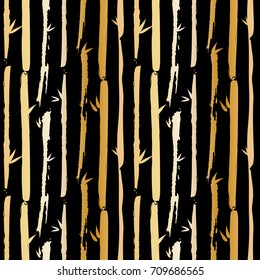 Seamless vector stripy pattern of bamboo and leaves. Gold forest on black background. Nature paintbrush lines background. Hand painted ink brush strokes. Stylish retro vintage stripes for T-shirt.