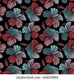 Seamless vector tropical design with hibiscus on a black background in orange and purple colors. Exotic flowers in allover composition. Pattern for summer fashion, interior, wallpaper.