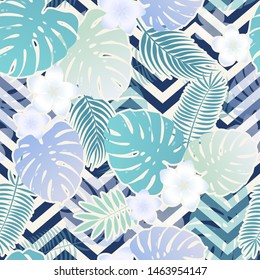Seamless vector tropical pattern with colorful exotic leaves and flowers on geometrical ornament