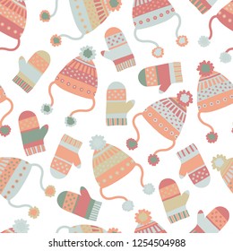 Seamless vector winter background with hats and mittens. Pattern tile with knitted clothes in pastel hues. Winter wear design, flat Scandinavian style. Use for paper, banner, cards, poster, fabric.