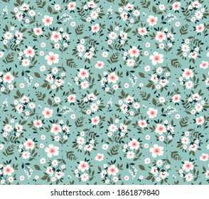 Seamless vintage floral pattern. Beautiful white flowers and green leaves on light blue background. Delicate flowers in ditsy style. Stock vector for prints on surface. Stock.