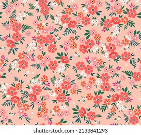 Seamless vintage floral pattern. Beautiful red and orange flowers and green leaves on light coral background. Delicate flowers in liberty style. Stock vector for prints on surface.