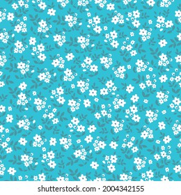 Seamless vintage pattern abstract. bright blue background. small white flowers. dark blue leaves. vector texture. trend print for textiles and wallpaper.