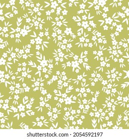 Seamless vintage pattern abstract. the ornament is white flowers and leaves on an olive background. vector texture. fashionable print for textiles, wallpaper and packaging.