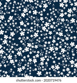 Seamless vintage pattern abstract. small white flowers and leaves on a dark blue background. vector texture . trend print for textiles .