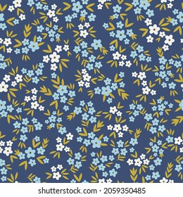 Seamless vintage pattern abstract. small white and blue flowers and green leaves on a dark blue background. vector texture. fashionable print for textiles, wallpaper and packaging.