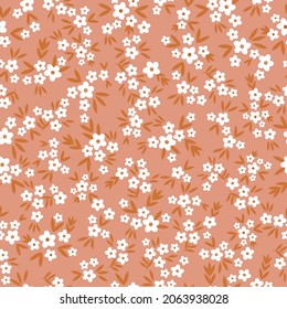 Seamless vintage pattern abstract. small white flowers and terracotta leaves on a beige background. vector texture. fashionable print for textiles, wallpaper and packaging.