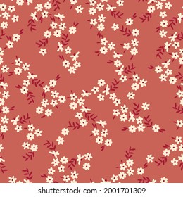abstracto de patrón vintage sin inconvenientes. fondo terracota. flores blancas pequeñas. textura vectorial. impresión de tendencia para textiles y papel pintado.