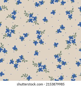 Seamless vintage pattern. Blue flowers and dots, green leaves. Beige background. vector texture. fashionable print for textiles, wallpaper and packaging.