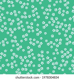 Seamless vintage pattern. bright green background. small white flowers . vector texture. fashionable print for textiles and wallpaper.