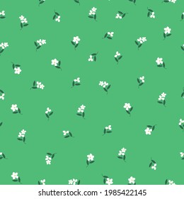 Seamless vintage pattern . bright green background. white flowers. dark green leaves. vector texture. trend print for textiles and wallpaper.
