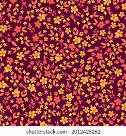 seamless vintage pattern . burgundy background. small orange and red flowers. vector texture. fashionable print for textiles and wallpaper.